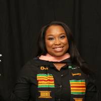 woman with blue and white pom poms